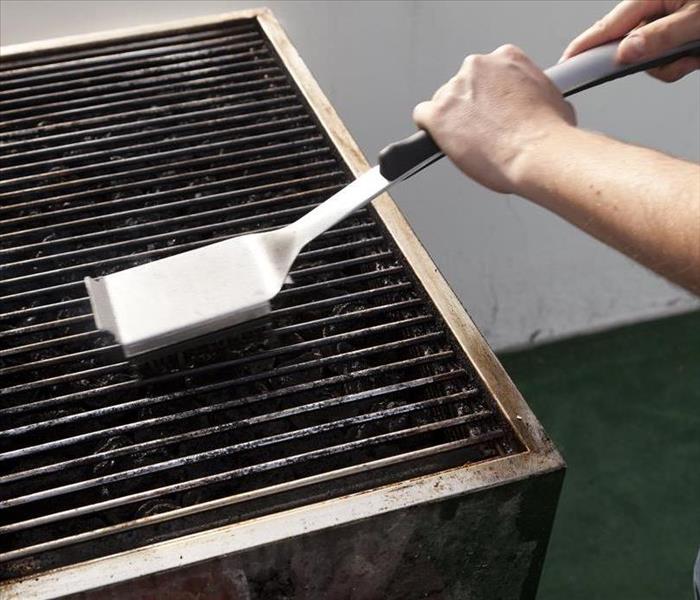An owner cleaning a Backyard Grill